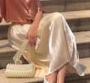 Upgrade Your Wardrobe with Our Spring and Autumn Half Length Pleated Skirt - Featuring Pearlescent Fabric and Elegant Pleats!